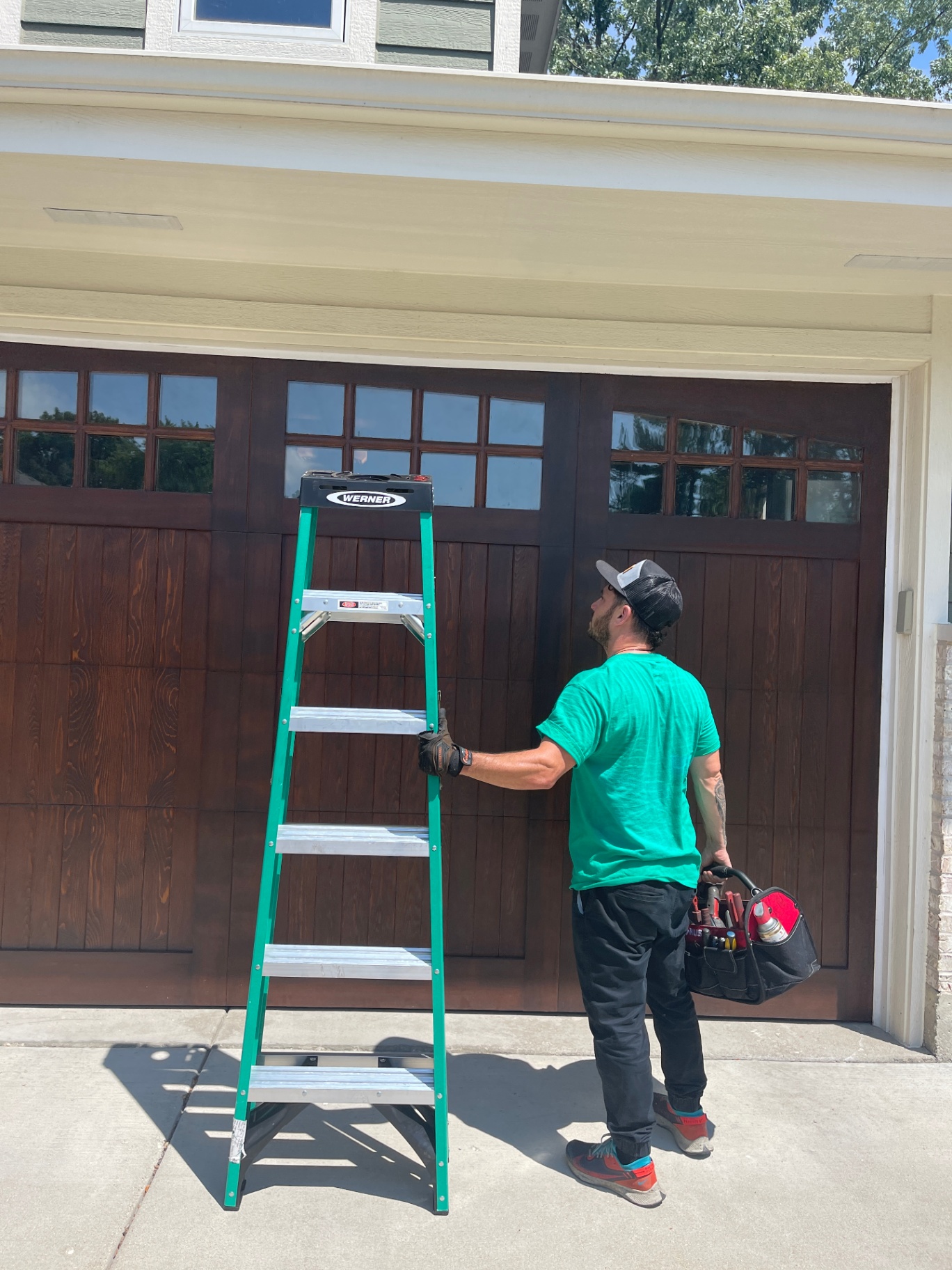 Green Garage Door Repair technician at a residential garage in Lighthouse Point and Broward County
